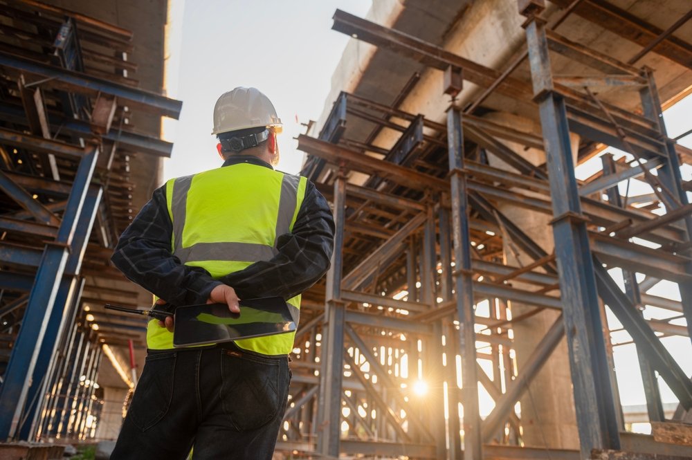 Engineer,Architect,In,Safety,Clothes,And,Helmet,Working,On,Tollway